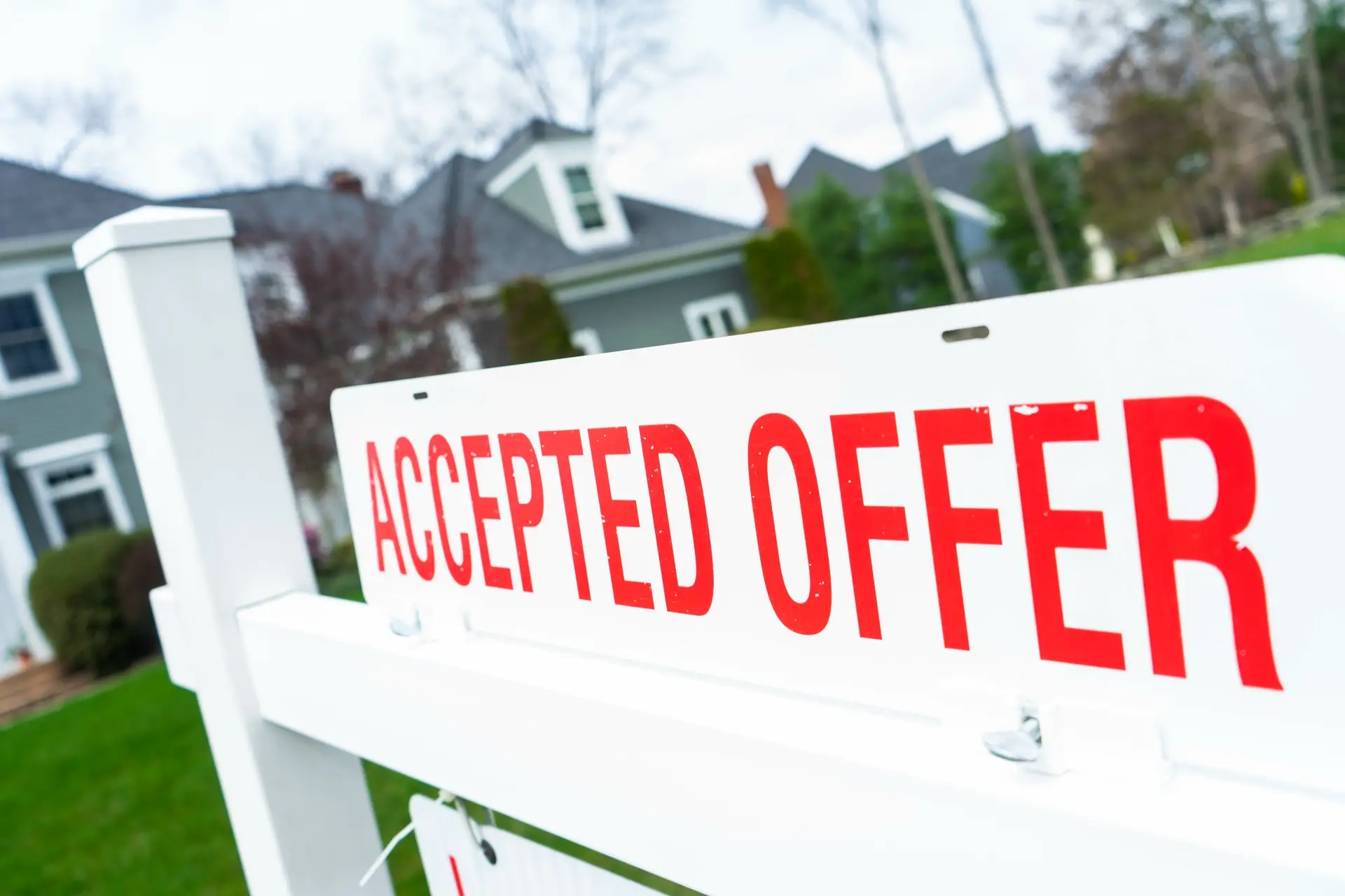 A sold sign in a yard after a homebuyer learned how to get your offer accepted on a house.